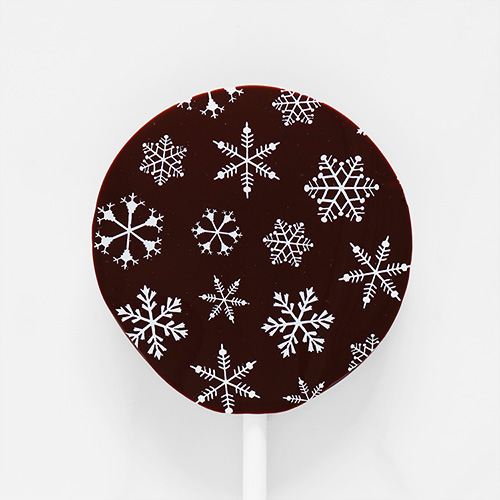 Dark Chocolate Christmas Lollipop with Seasonal Pattern Overhead Close Up