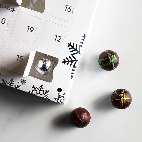 Luxury Advent Calendar with Chocolates In and Out of Window Overhead Close Up